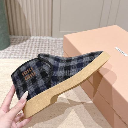 MIUMIU 25S SLIP-ON BOOTIES IN BLACK AND BLUE WOOL WITH SHEARLING