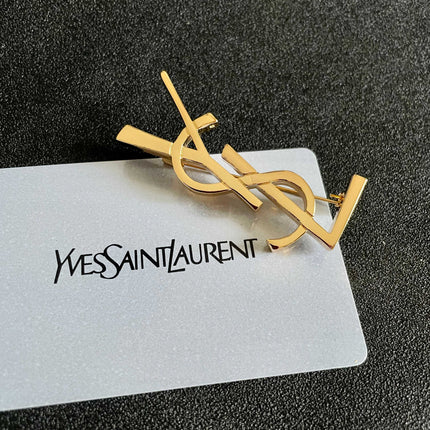YSL 26S MONOGRAM BROOCH IN GOLD TONE METAL 630942