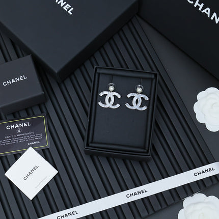 DOUBLE C EARRINGS IN SILVER METAL WITH BLACK SNOWFLAKE EMBOSSED ON WHITE ENAMEL