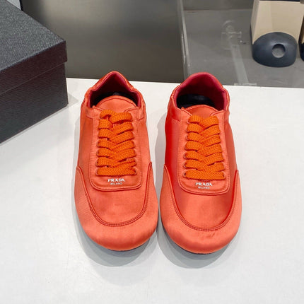 PRADA 26S SNEAKERS IN BURNT ORANGE SATIN