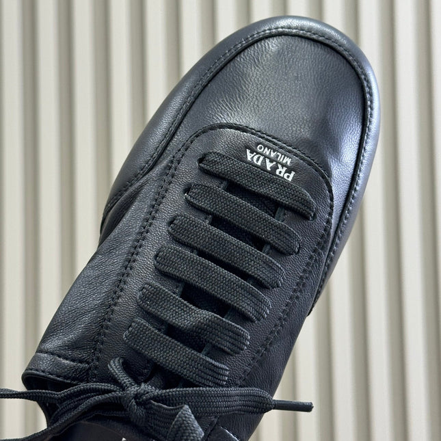 PRADA 25S COLLAPSE MULES IN BLACK CALFSKIN