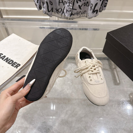 PRADA 26S COLLAPSE SNEAKERS IN WHITE CANVAS